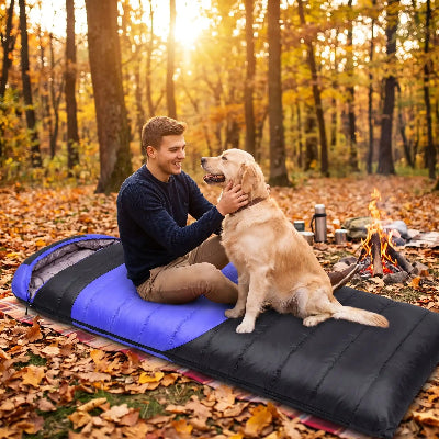 foret d'automne homme joue avec chien sur sac de couchage chauffant Thermix.